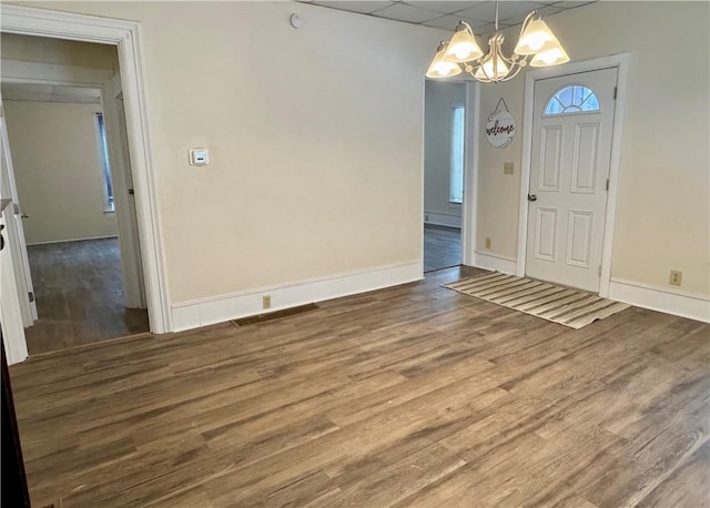 interior space featuring hardwood / wood-style floors and a notable chandelier