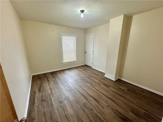 spare room with dark hardwood / wood-style flooring