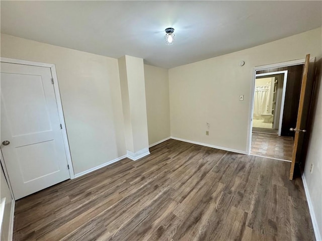 unfurnished room featuring dark wood-type flooring