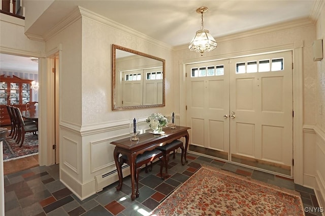 foyer entrance with ornamental molding, a baseboard heating unit, and an inviting chandelier