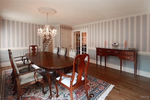 dining area with ornamental molding, dark hardwood / wood-style floors, and a notable chandelier