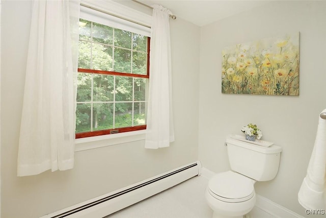 bathroom featuring toilet, a wealth of natural light, and a baseboard heating unit