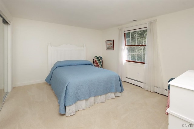 carpeted bedroom with baseboard heating