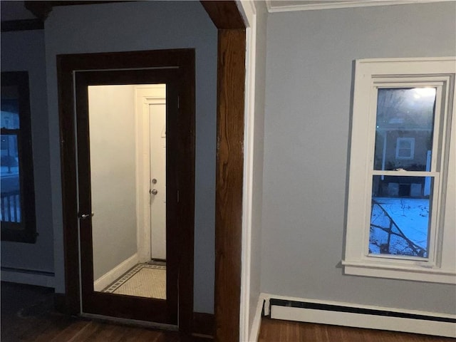 hall featuring a baseboard heating unit and dark hardwood / wood-style floors