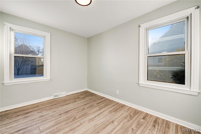 spare room with light hardwood / wood-style floors