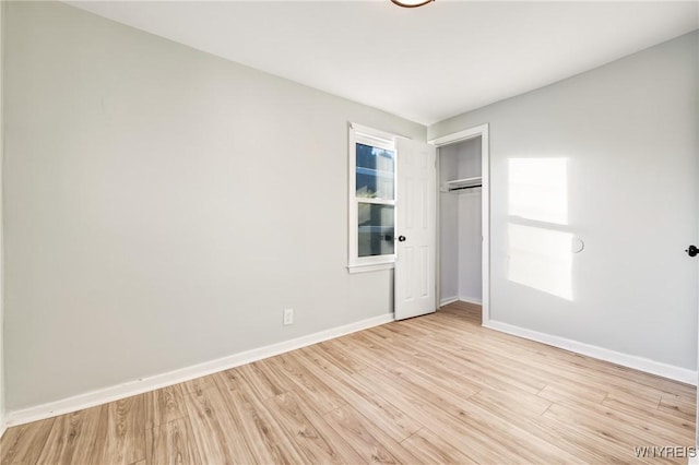 unfurnished bedroom featuring a closet and light hardwood / wood-style flooring