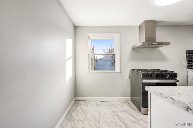 kitchen with wall chimney exhaust hood and range with gas cooktop