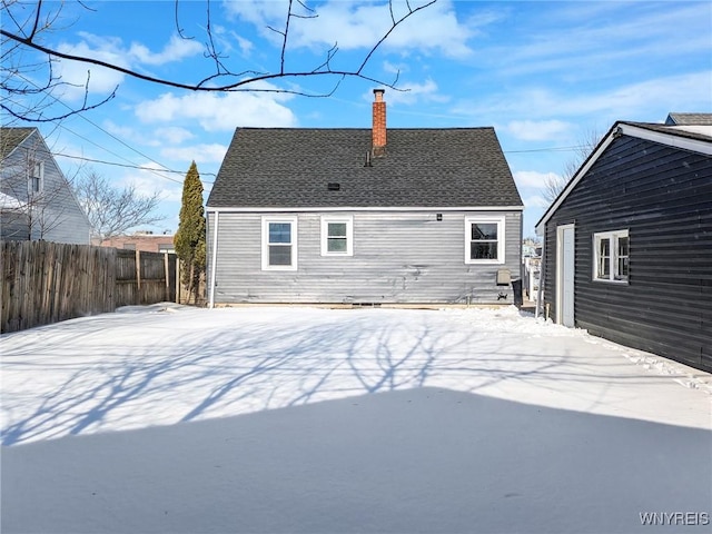 view of snow covered back of property