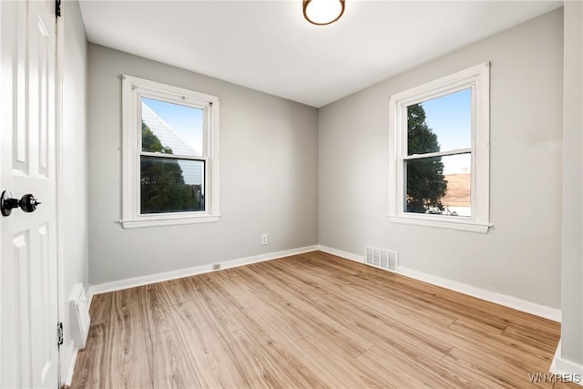 unfurnished room with light hardwood / wood-style flooring