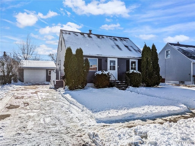 view of front of house with a garage and an outdoor structure