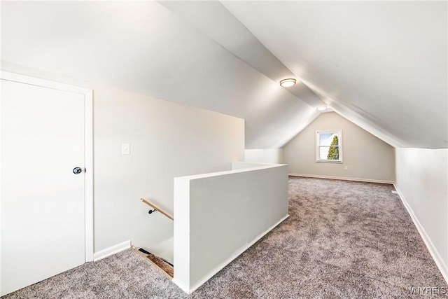 additional living space featuring lofted ceiling and carpet floors