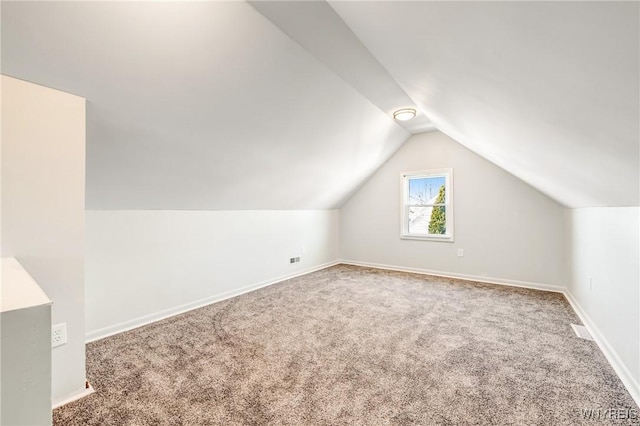 bonus room featuring vaulted ceiling and carpet flooring