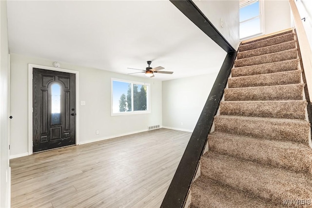 foyer entrance with wood-type flooring and ceiling fan