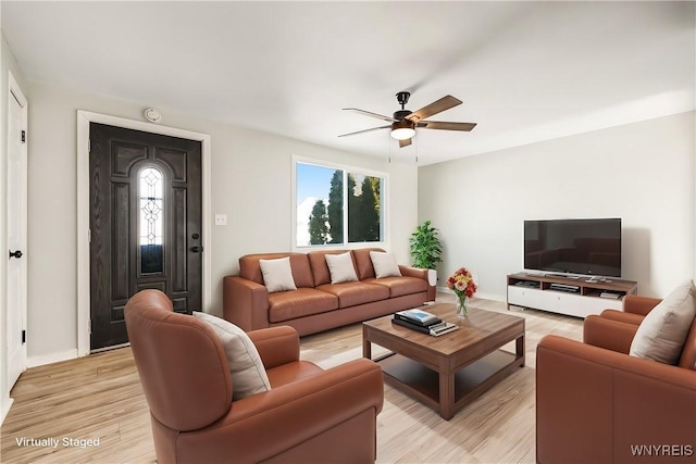 living room featuring ceiling fan and light hardwood / wood-style floors