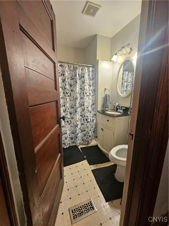 bathroom featuring vanity and curtained shower