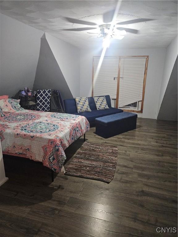 bedroom with ceiling fan and dark hardwood / wood-style floors