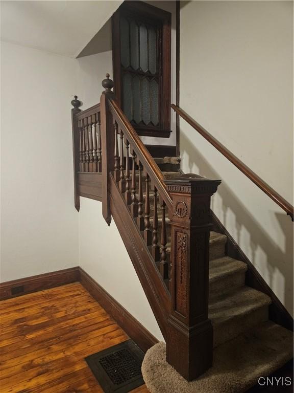 stairway with hardwood / wood-style flooring