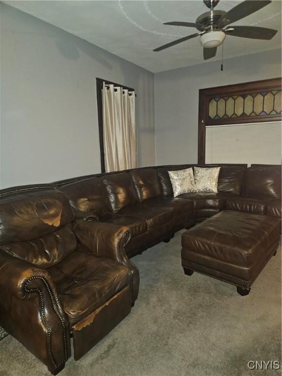 living room featuring carpet floors and ceiling fan