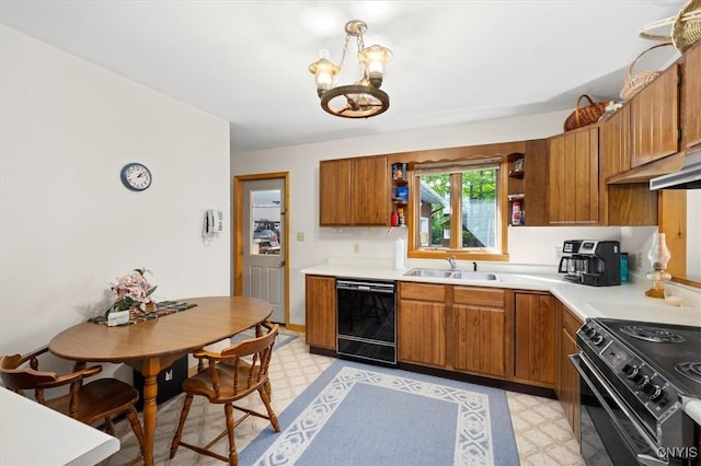 kitchen with sink, an inviting chandelier, and black appliances