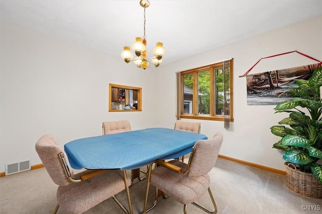 dining area with an inviting chandelier and carpet