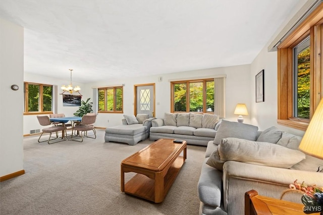 living room featuring a notable chandelier and carpet flooring