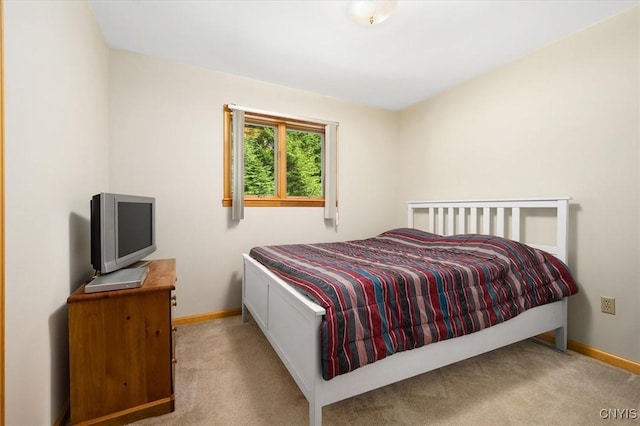 bedroom featuring light carpet