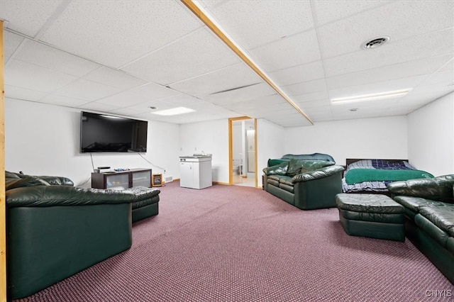 carpeted living room featuring a paneled ceiling