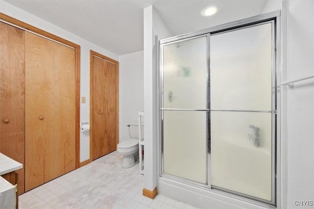 bathroom with walk in shower and toilet