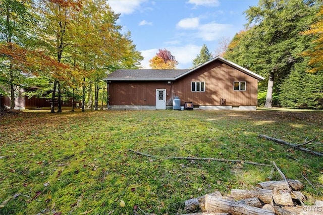 back of property featuring a lawn