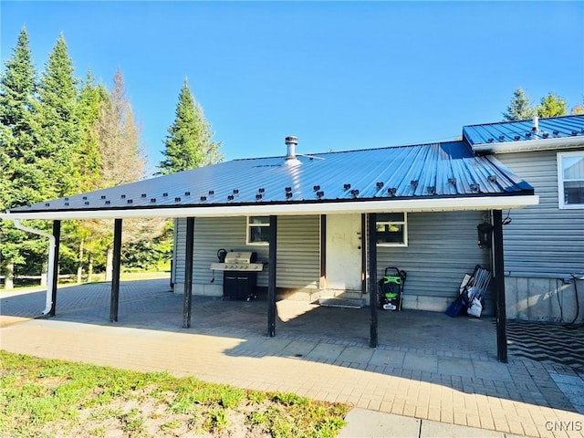 back of house featuring a carport