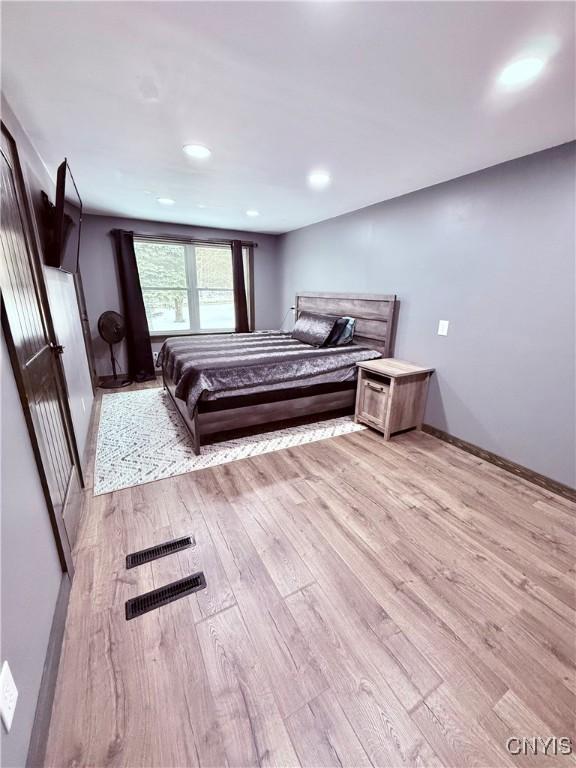 bedroom with light wood-type flooring