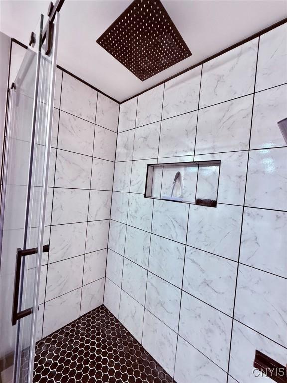 bathroom with tiled shower