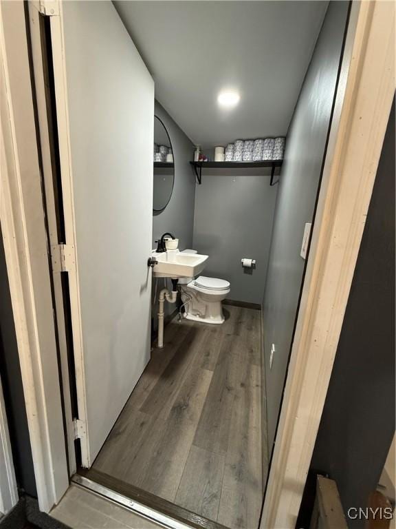 bathroom featuring hardwood / wood-style flooring, sink, and toilet