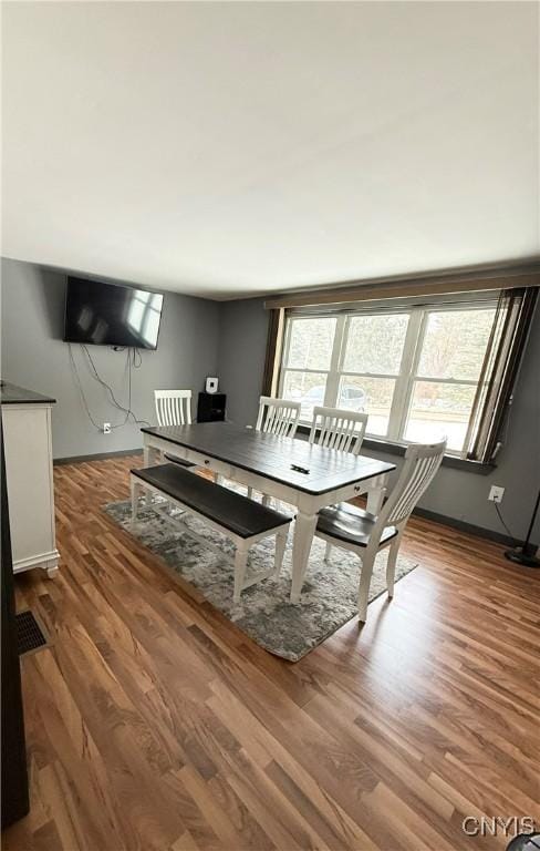 dining area with dark hardwood / wood-style flooring