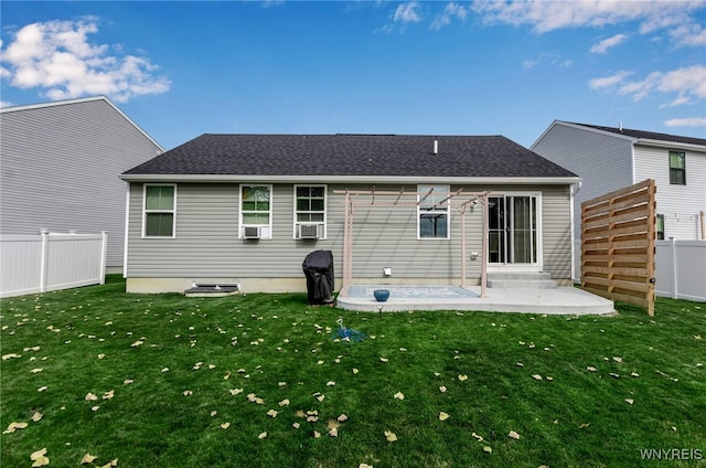 back of property featuring cooling unit, a patio area, and a lawn