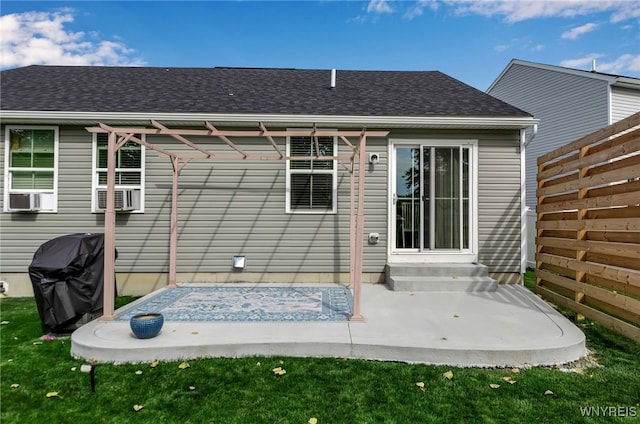 rear view of property with cooling unit and a yard