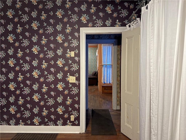 hallway with wood-type flooring