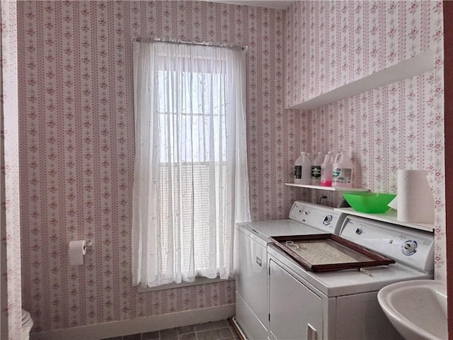 clothes washing area with sink, tile patterned floors, and independent washer and dryer