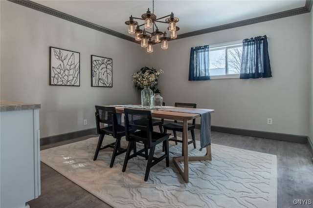 dining area featuring hardwood / wood-style flooring, crown molding, and a notable chandelier