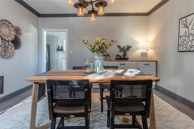 dining area with a notable chandelier and ornamental molding