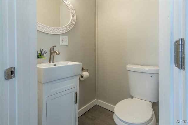 bathroom with vanity, hardwood / wood-style flooring, and toilet