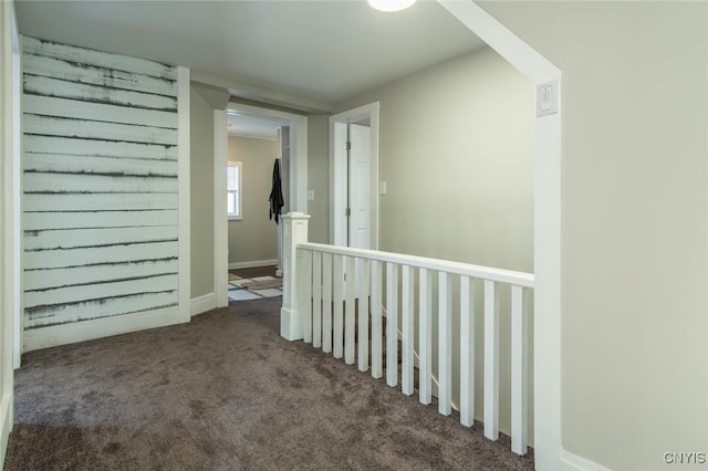 corridor with dark colored carpet