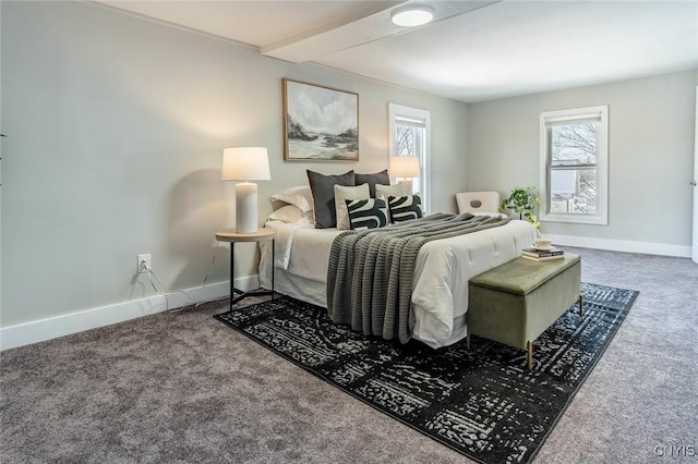 carpeted bedroom with beamed ceiling