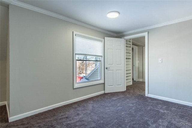 unfurnished bedroom with crown molding and dark carpet