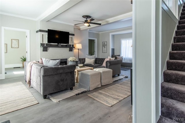 living room with ornamental molding and light hardwood / wood-style floors