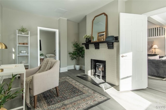 office featuring hardwood / wood-style flooring and a fireplace