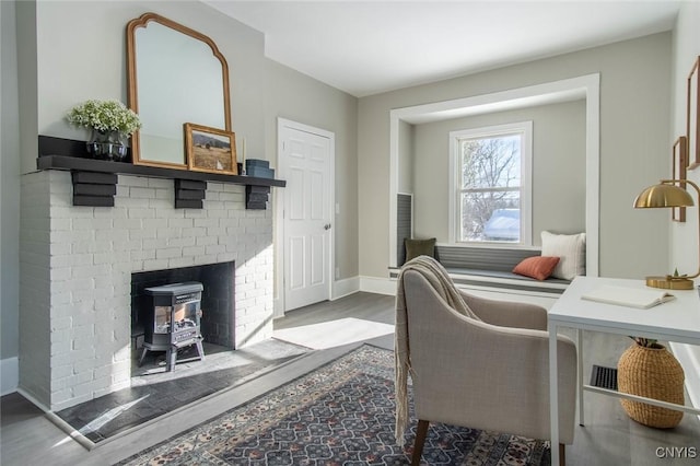 interior space featuring hardwood / wood-style floors and a wood stove