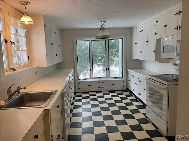 kitchen with pendant lighting, sink, white appliances, a textured ceiling, and white cabinets