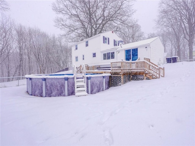 snow covered property featuring a swimming pool side deck