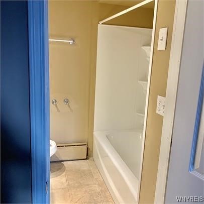 bathroom featuring a baseboard radiator, tile patterned floors, and toilet